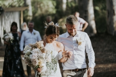 Bride holding flowers and Groom 